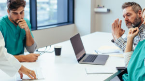 Group of medical professionals brainstorming in a meeting.